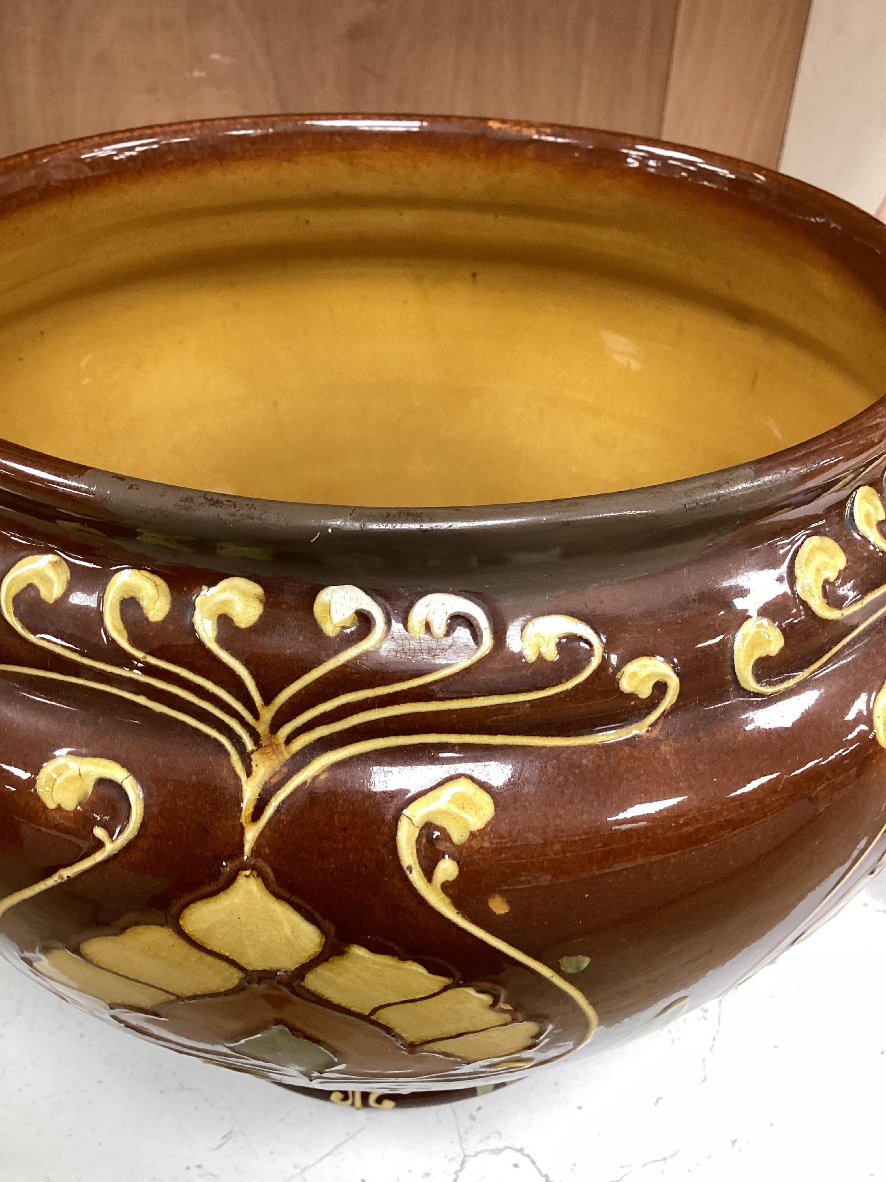 A Wardle decorative Arts and Crafts pottery jardiniere together with a green glazed jardiniere (2). Condition - fair